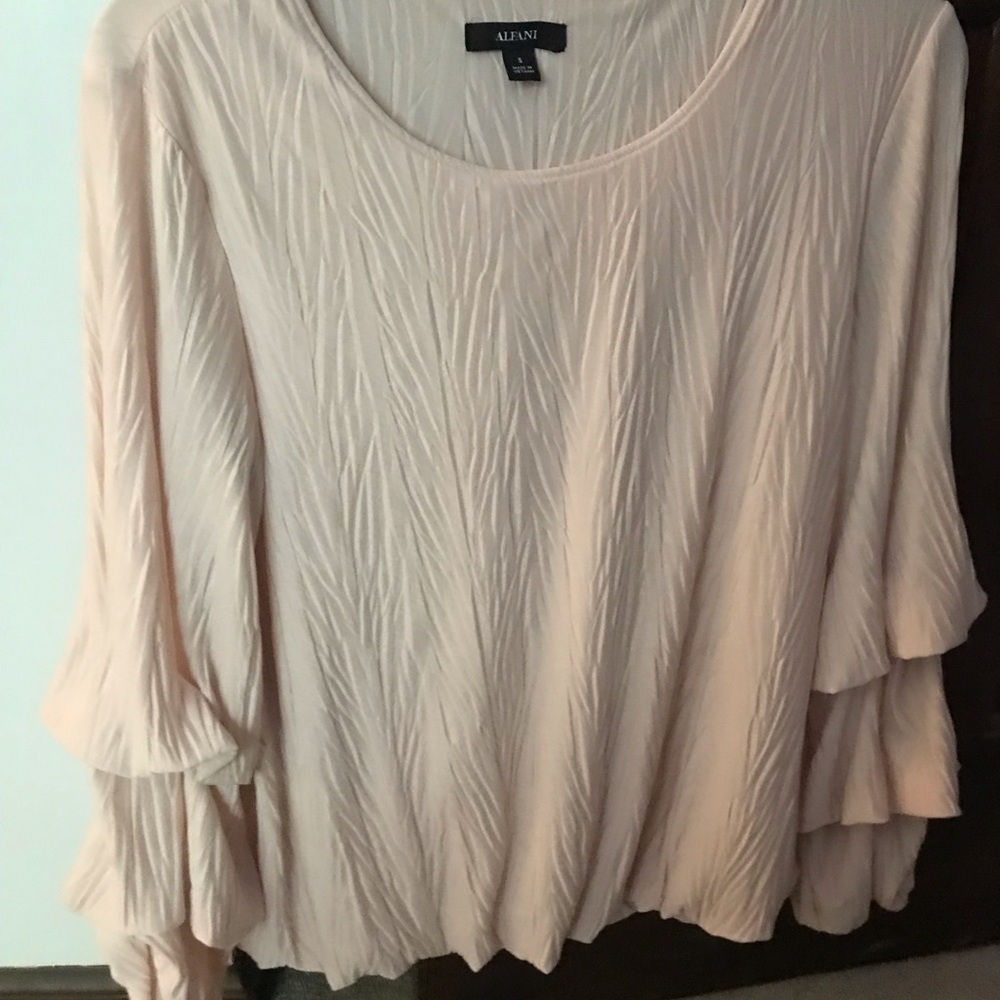 Women’s blouson top with trumpet sleeves.